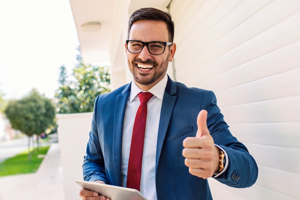 Salesman smiling about all of his sales representative tax deductions